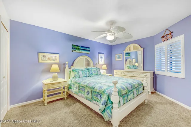 a bedroom with a bed table and window