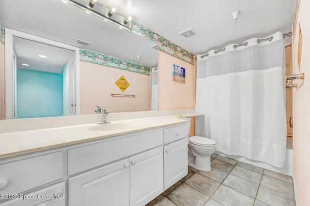 a spacious bathroom with a double vanity sink toilet mirror and shower