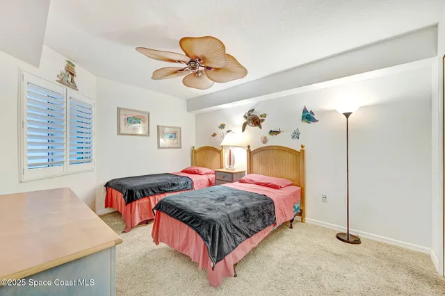 a bedroom with bed and a chandelier