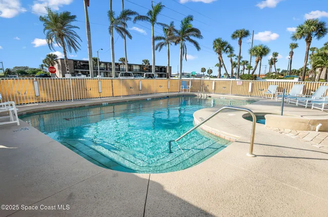a view of a swimming pool with a patio and a swimming pool