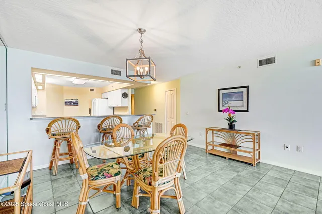 a view of a dining room with furniture wooden floor and a chandelier