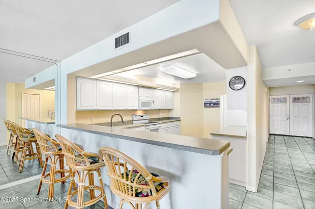 a large kitchen with a large window and stainless steel appliances
