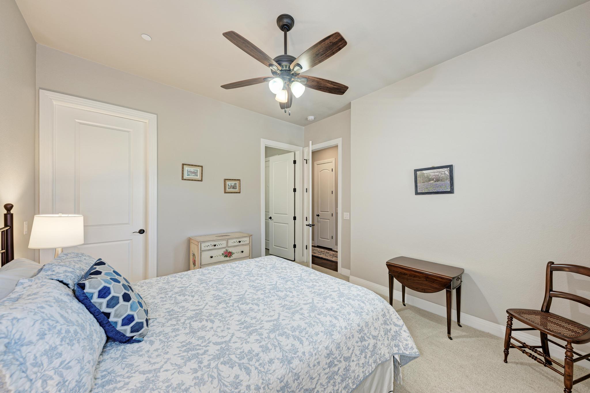 2601 North Quinlan Park Road, Unit 506 Austin, TX 78732 - Photo 28 of 39 An inviting bedroom features soft carpeting, recessed lighting, and a ceiling fan for year-round comfort.