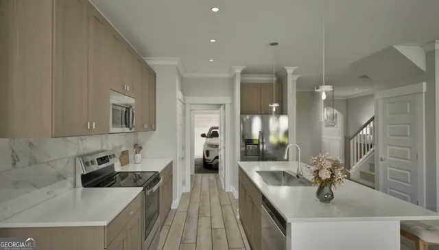 a kitchen with stainless steel appliances granite countertop a sink dishwasher stove and refrigerator