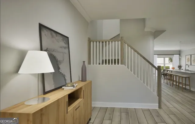 a view of a hallway with wooden floor and staircase
