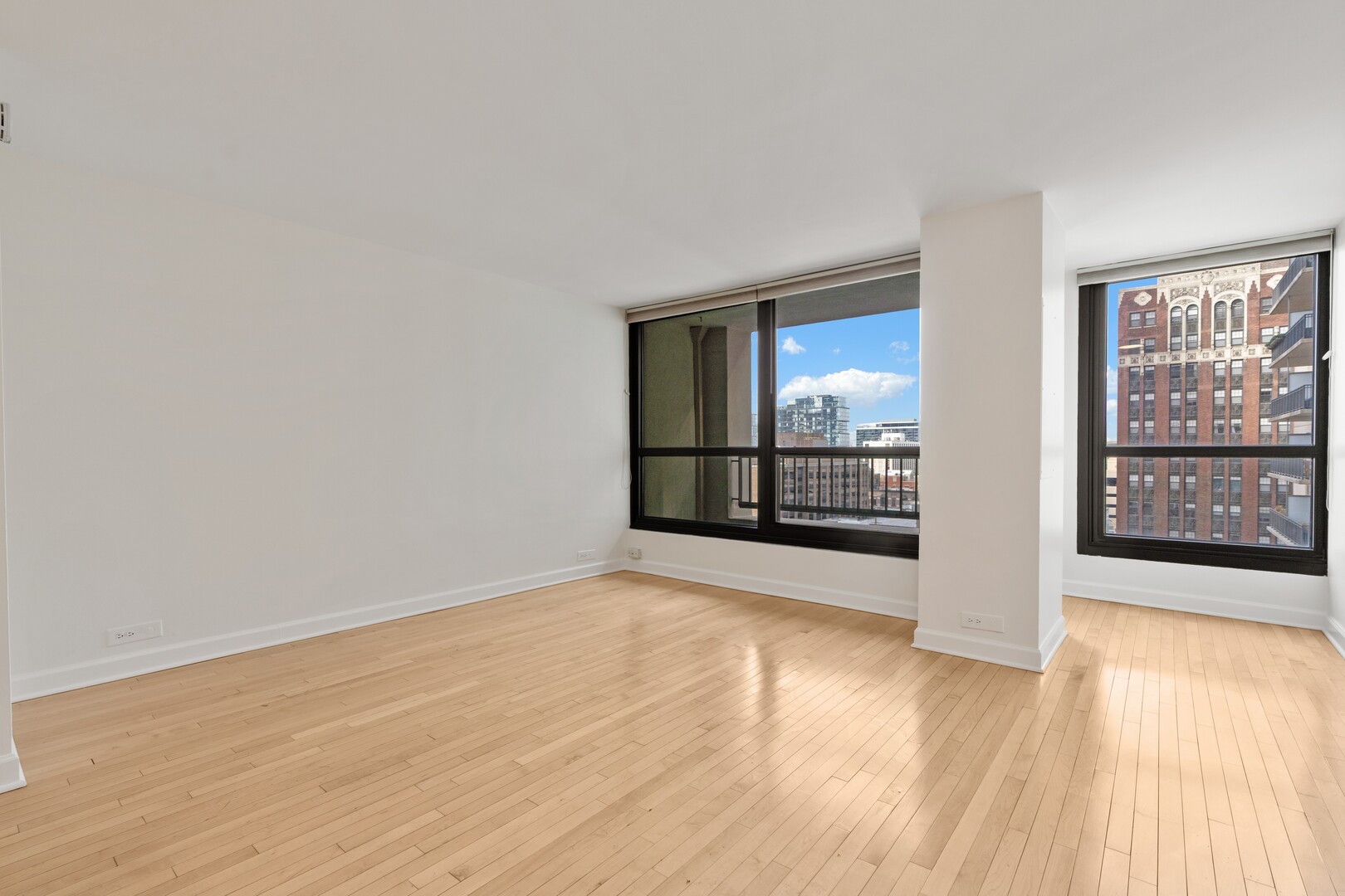 1030 North State Street, Unit 5M Chicago, IL 60610 - Photo 3 of 14 wooden floor in an empty room with a window