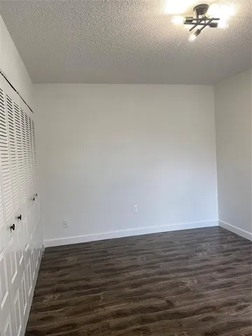 a view of an empty room and wooden floor