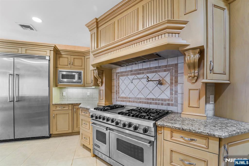 1 Euclid Road Fort Lee, NJ 07024 - Photo 11 of 50 a kitchen with stainless steel appliances granite countertop a stove and a refrigerator