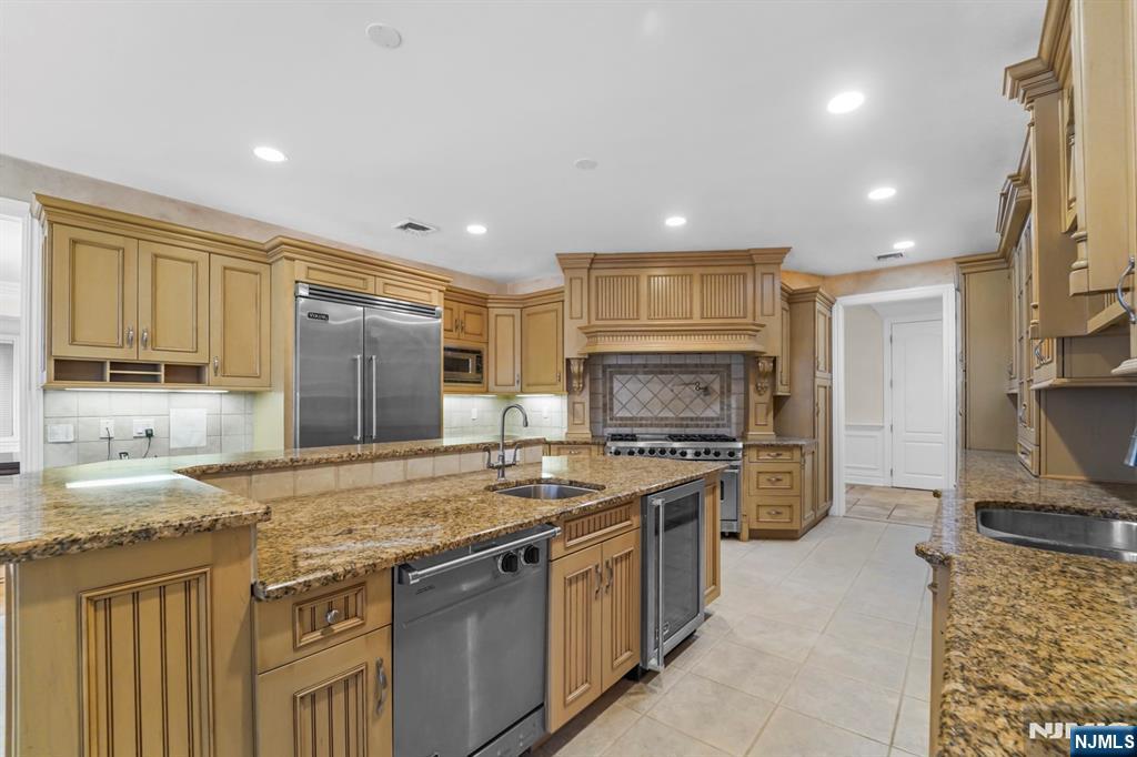 1 Euclid Road Fort Lee, NJ 07024 - Photo 12 of 50 a kitchen with stainless steel appliances granite countertop a sink stove and refrigerator