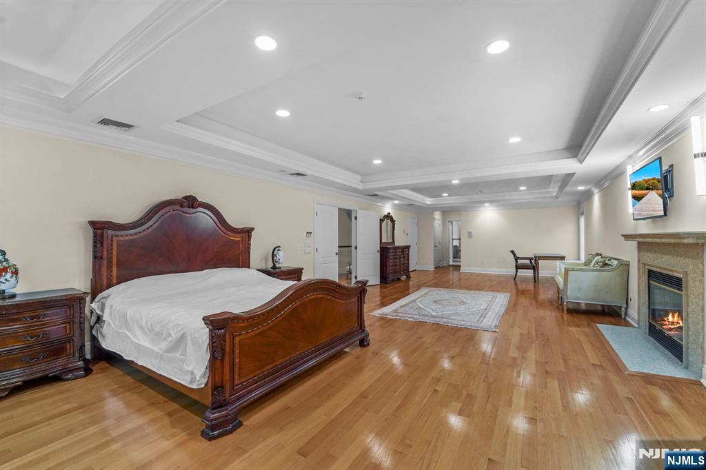 1 Euclid Road Fort Lee, NJ 07024 - Photo 25 of 50 a spacious bedroom with a bed and a fireplace