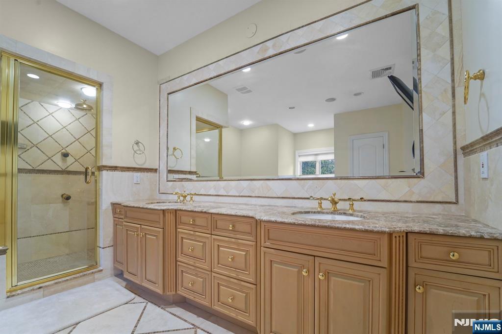1 Euclid Road Fort Lee, NJ 07024 - Photo 26 of 50 a bathroom with a granite countertop sink mirror and double