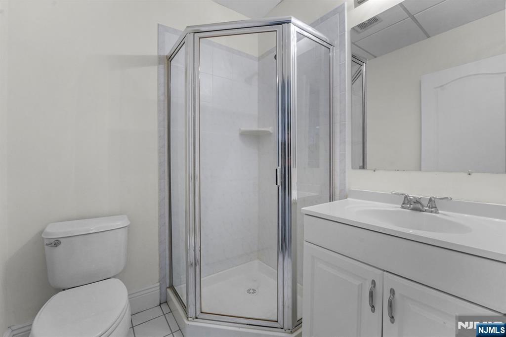 1 Euclid Road Fort Lee, NJ 07024 - Photo 39 of 50 a bathroom with a shower a toilet and sink