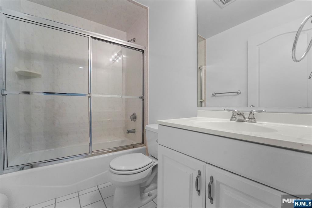 1 Euclid Road Fort Lee, NJ 07024 - Photo 43 of 50 a bathroom with a shower sink mirror vanity and toilet