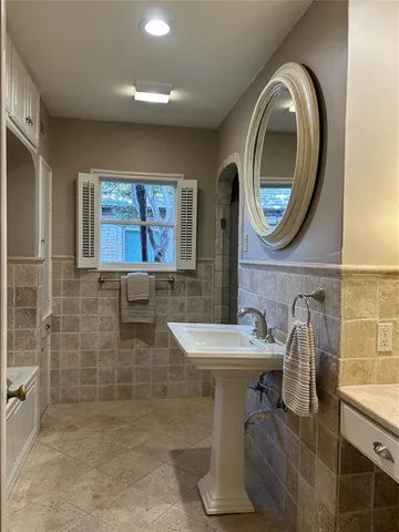 a bathroom with a sink a mirror and a toilet