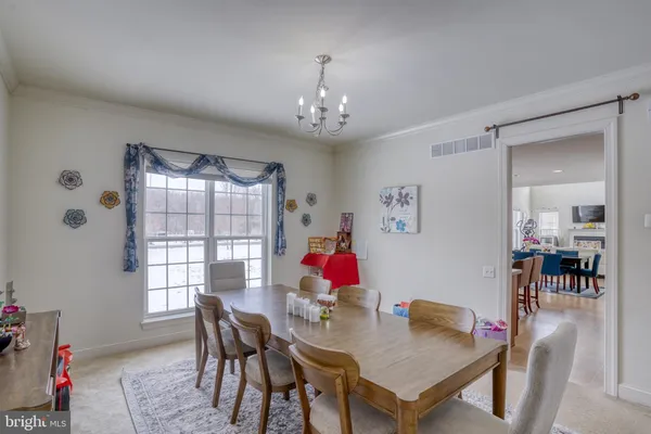 a view of a dining room with furniture and chandelier
