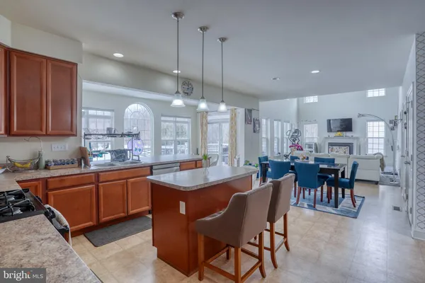 a large kitchen with a table and chairs