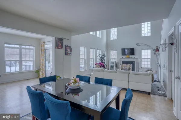 a living room with furniture a fireplace and a window