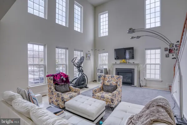 a living room with furniture a window and gym equipment