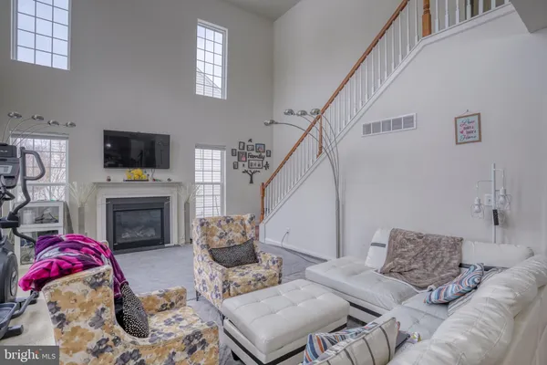 a living room with furniture a flat screen tv and a couch