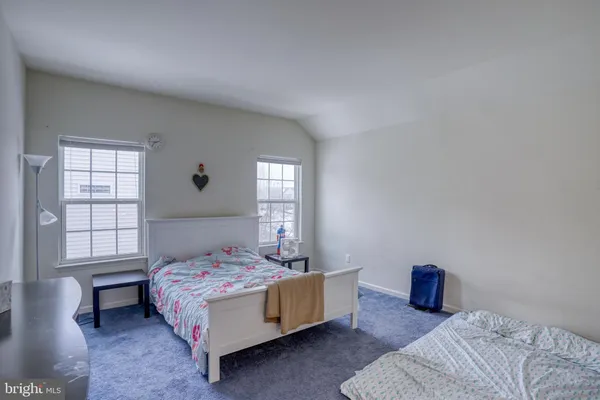 a bedroom with a bed and a mirror