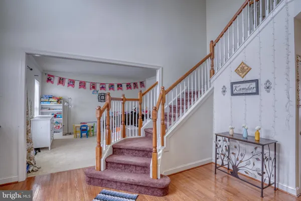 a view of entryway with stairs and wooden floor