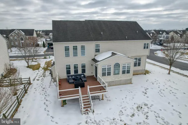 a view of a white house with a big yard next to a road