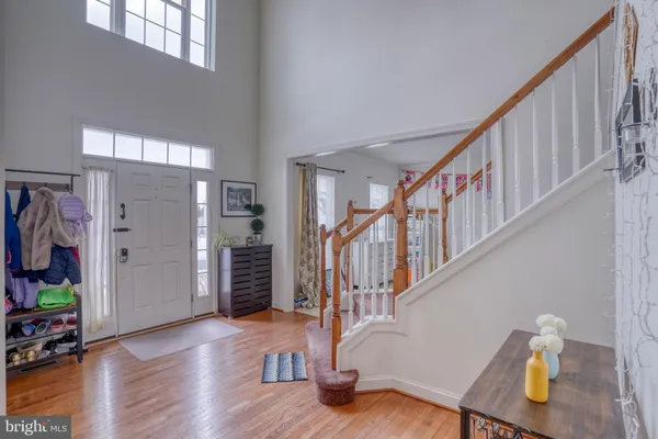 a view of entryway with wooden floor and stairs