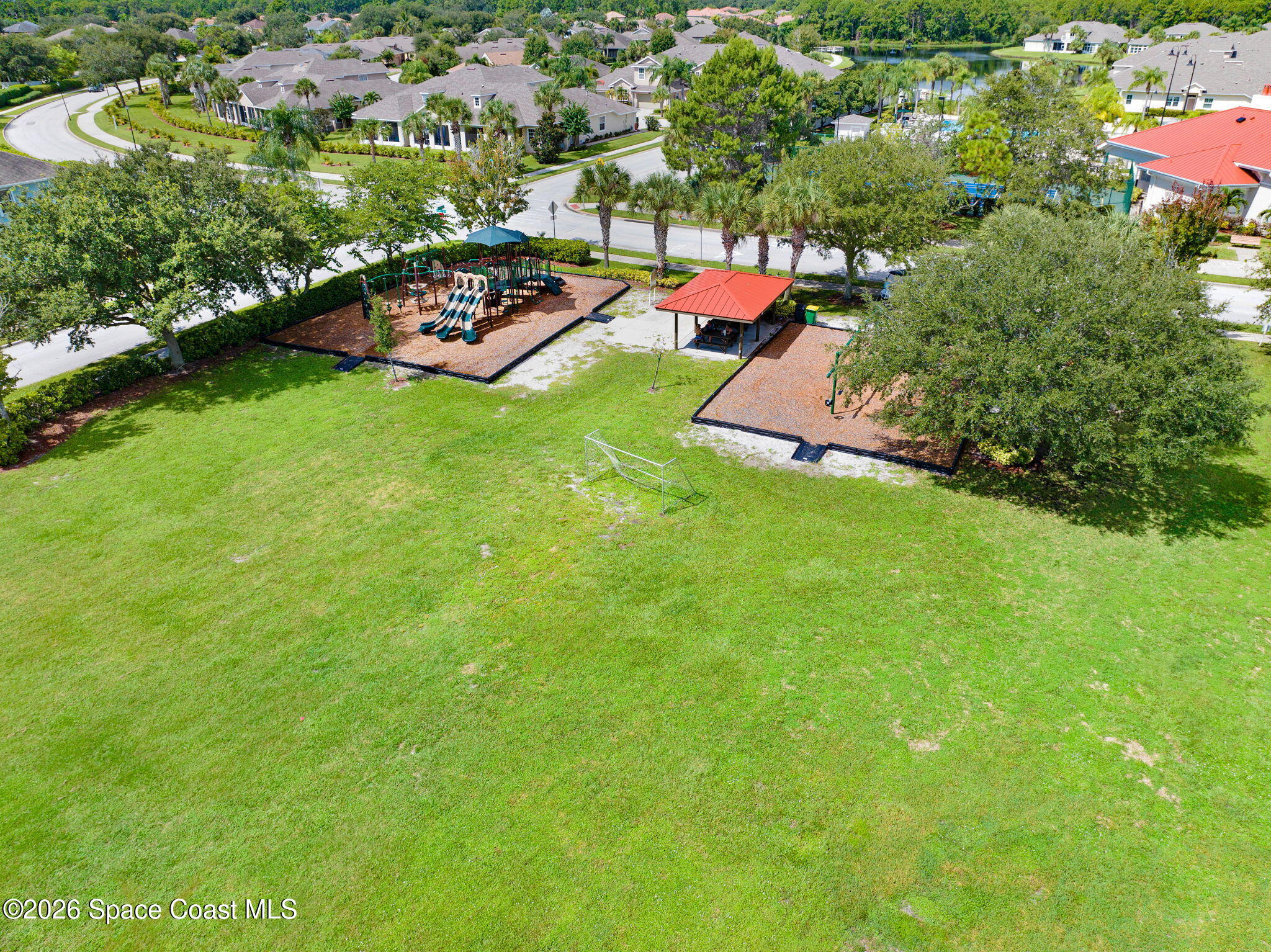 1202 Becket Place Melbourne, FL 32940 - Photo 33 of 69 an aerial view of a house with a garden and swimming pool