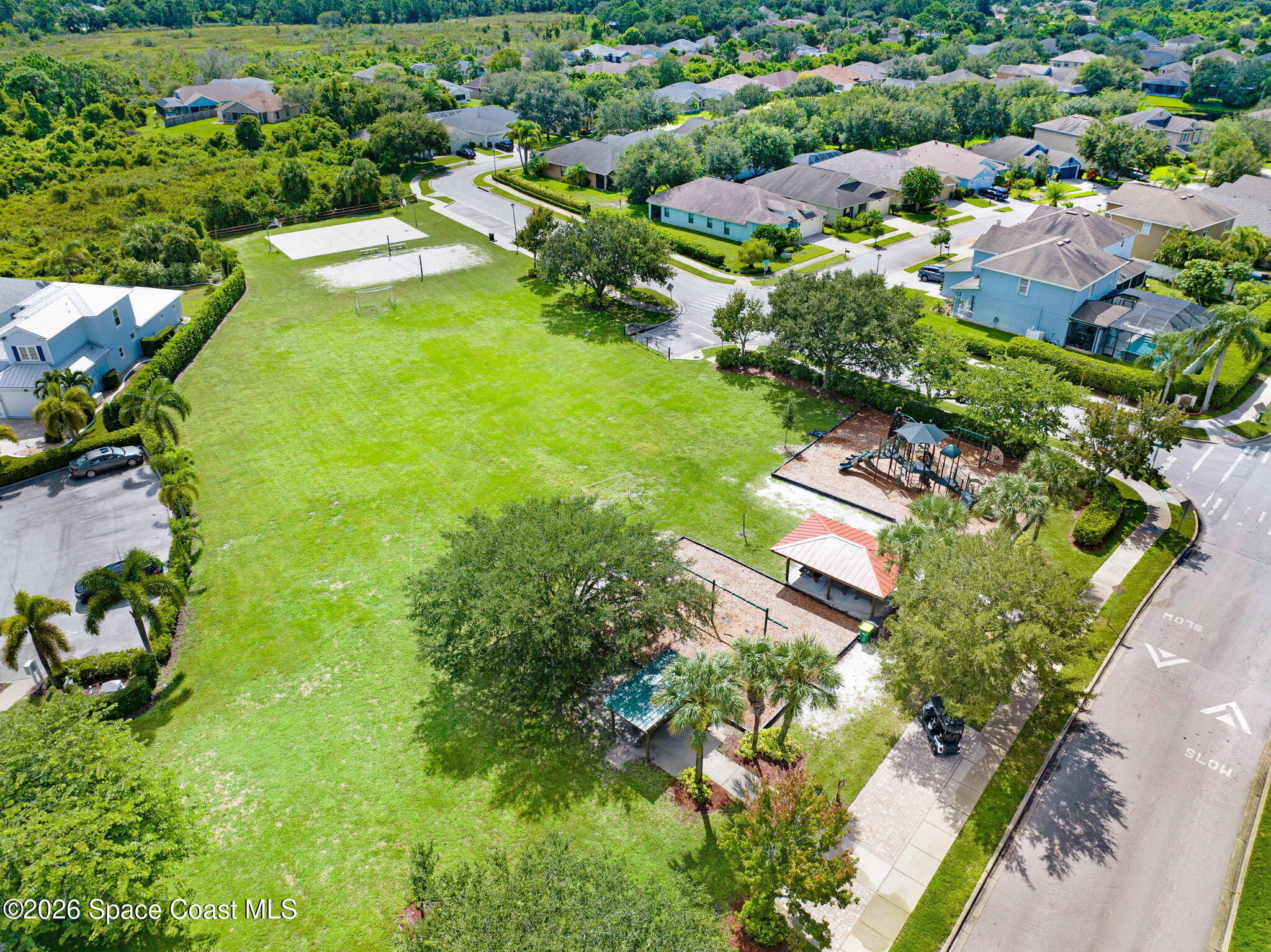 1202 Becket Place Melbourne, FL 32940 - Photo 34 of 69 an aerial view of residential houses with outdoor space and trees