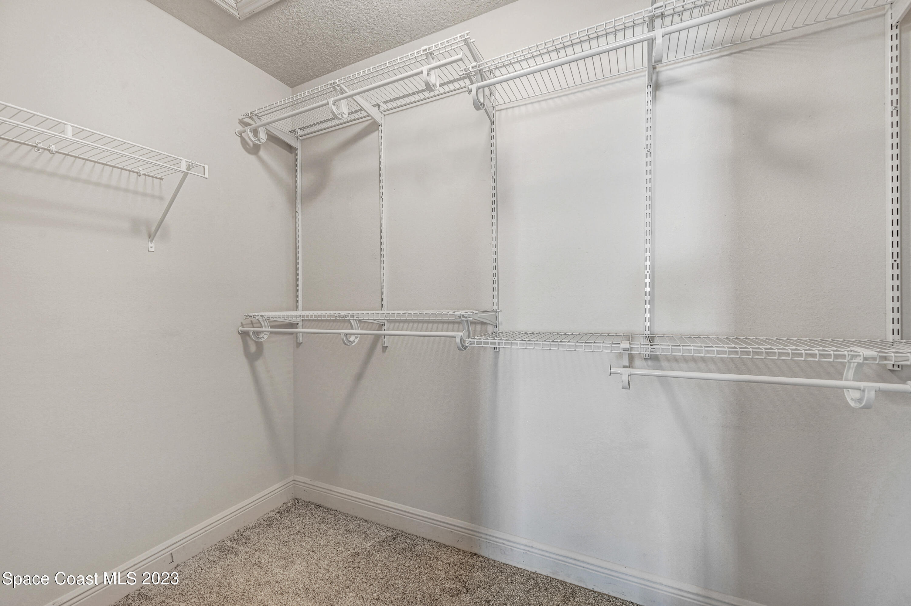 1202 Becket Place Melbourne, FL 32940 - Photo 4 of 69 a view of a room with racks on the wall