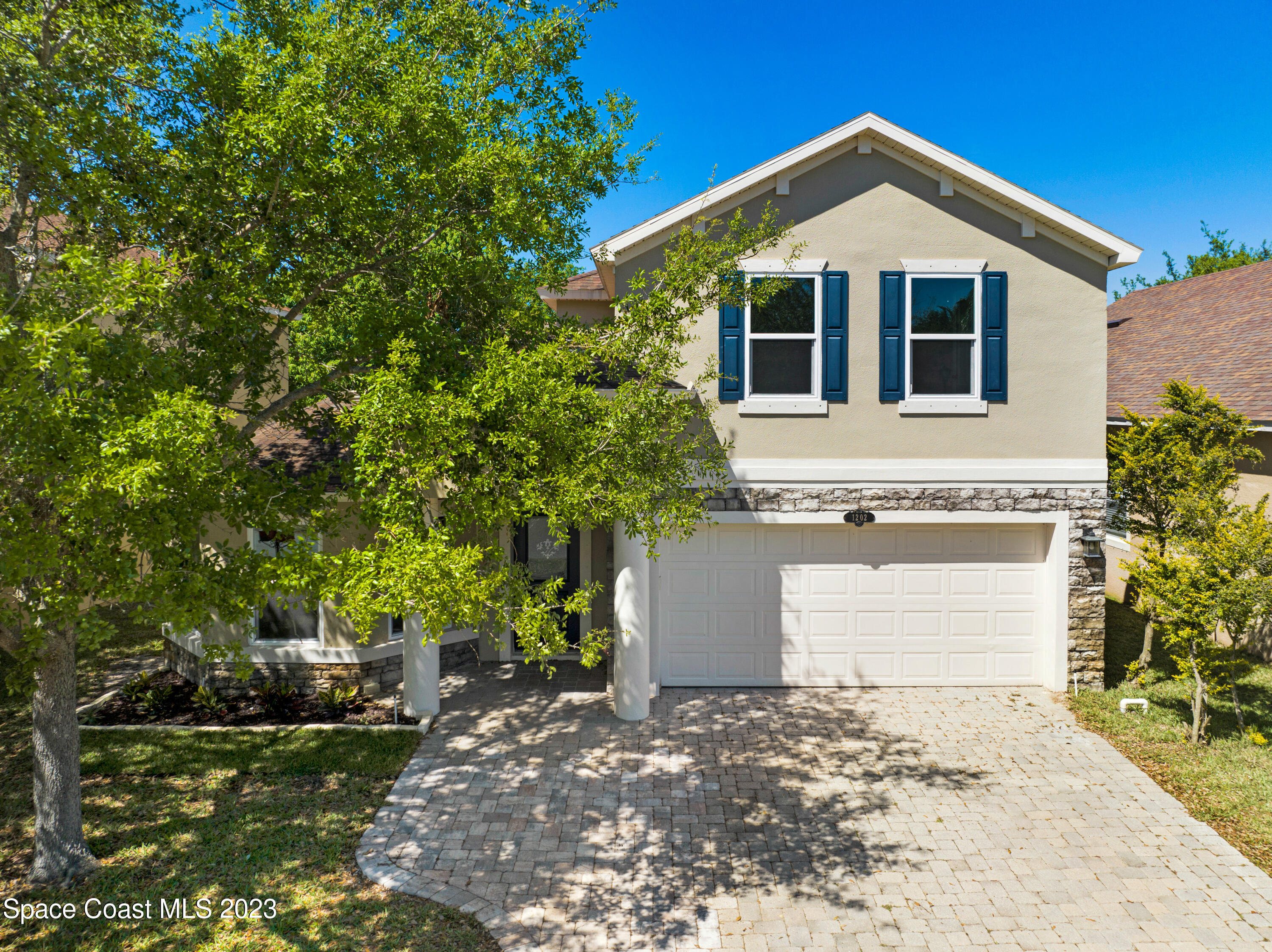1202 Becket Place Melbourne, FL 32940 - Photo 58 of 69 a front view of a house with a yard