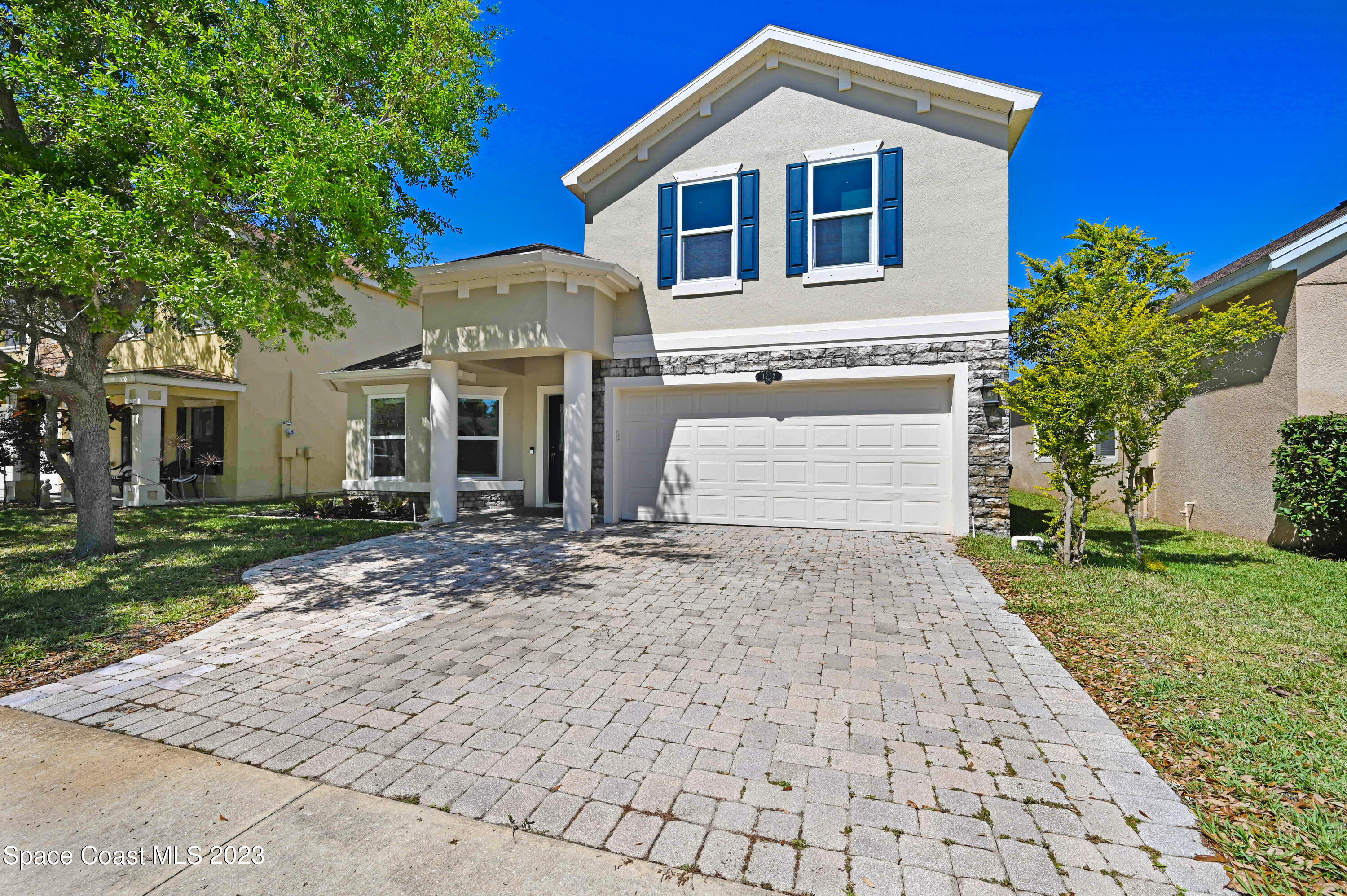 1202 Becket Place Melbourne, FL 32940 - Photo 62 of 69 a front view of a house with a yard and garage