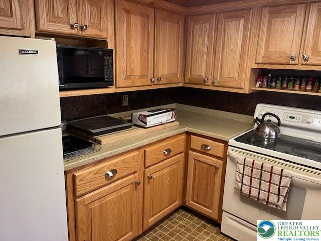 119 Little Mud Pond Road Dingmans Ferry, PA 18328 - Photo 5 of 23 a kitchen with granite countertop cabinets and black appliances