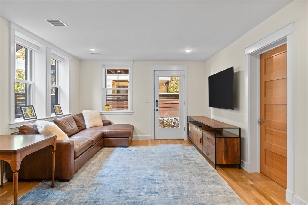 2 Village Street, Unit 2 Somerville, MA 02143 - Photo 11 of 18 a living room with furniture and a flat screen tv