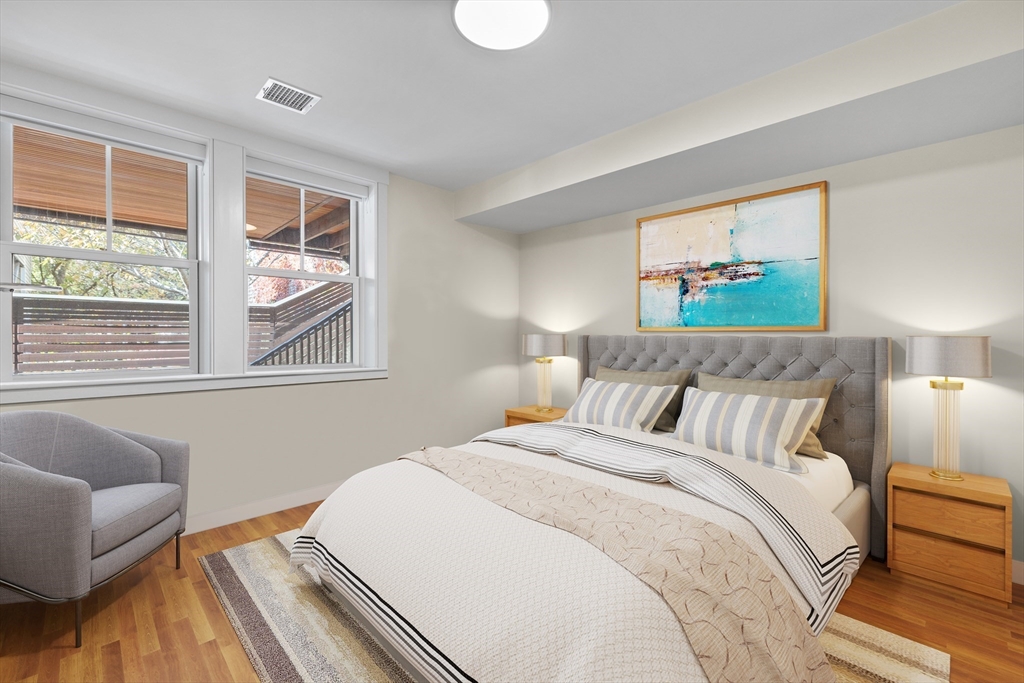 2 Village Street, Unit 2 Somerville, MA 02143 - Photo 12 of 18 a bedroom with bed and a couch