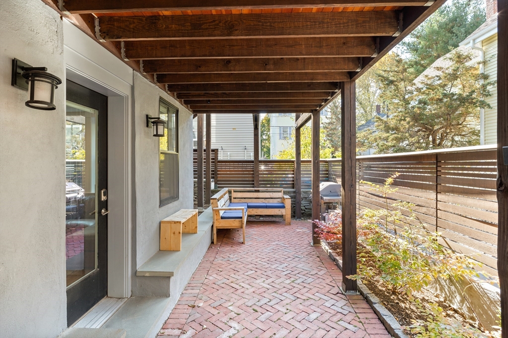 2 Village Street, Unit 2 Somerville, MA 02143 - Photo 15 of 18 a porch with a table and chairs next to a window