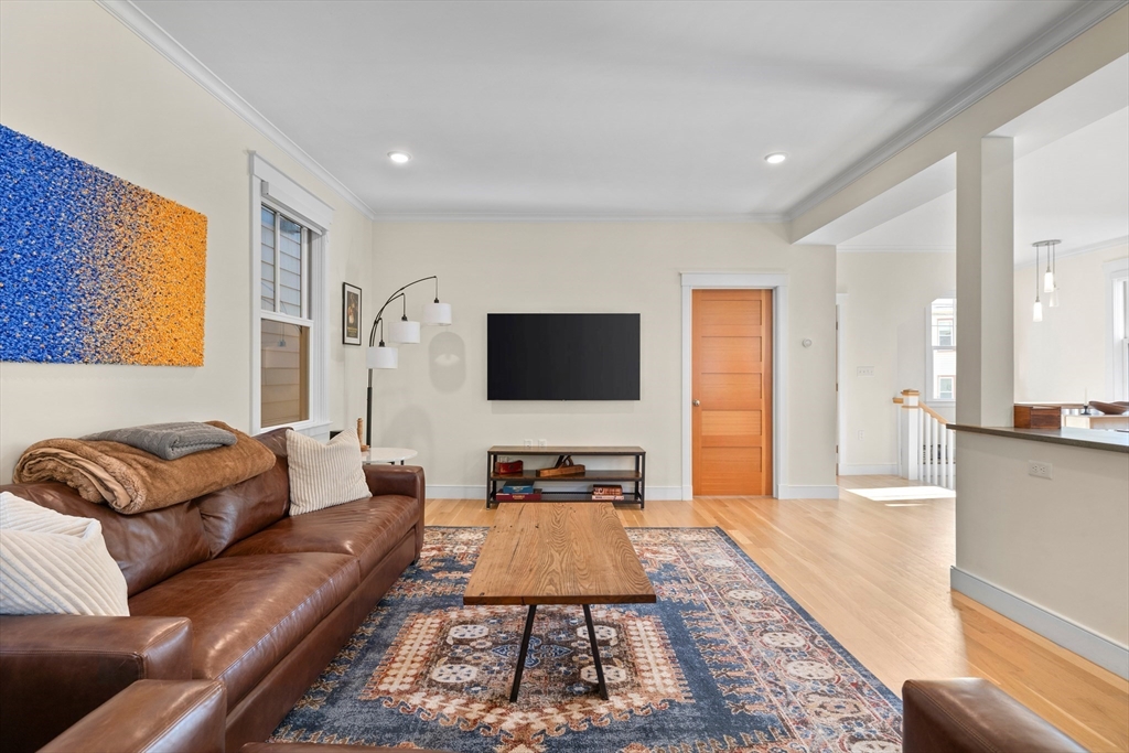 2 Village Street, Unit 2 Somerville, MA 02143 - Photo 3 of 18 a living room with furniture and a flat screen tv