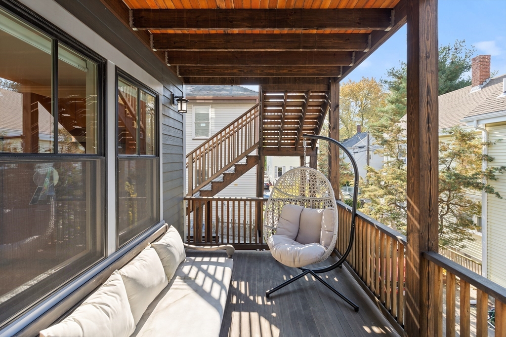 2 Village Street, Unit 2 Somerville, MA 02143 - Photo 5 of 18 a view of balcony with wooden floor and outdoor seating