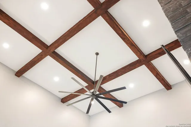 a view of a dining room with furniture a kitchen and chandelier
