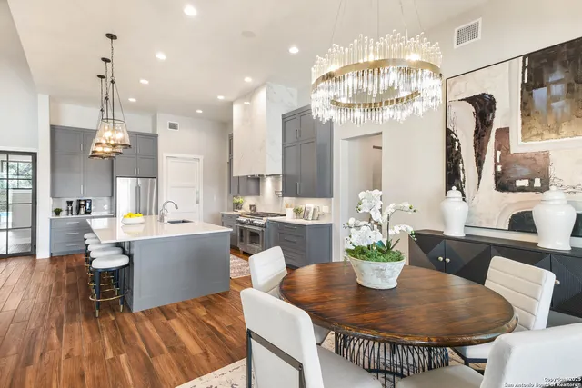 a open kitchen with stainless steel appliances granite countertop a lot of counter space and wooden floors