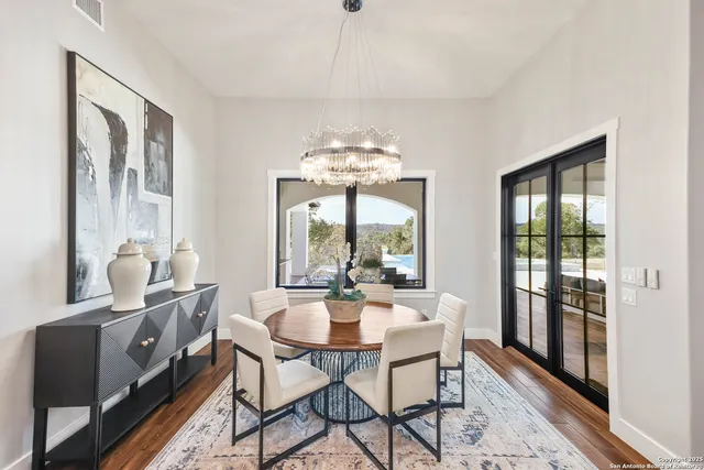 a bedroom with a large bed and a chandelier