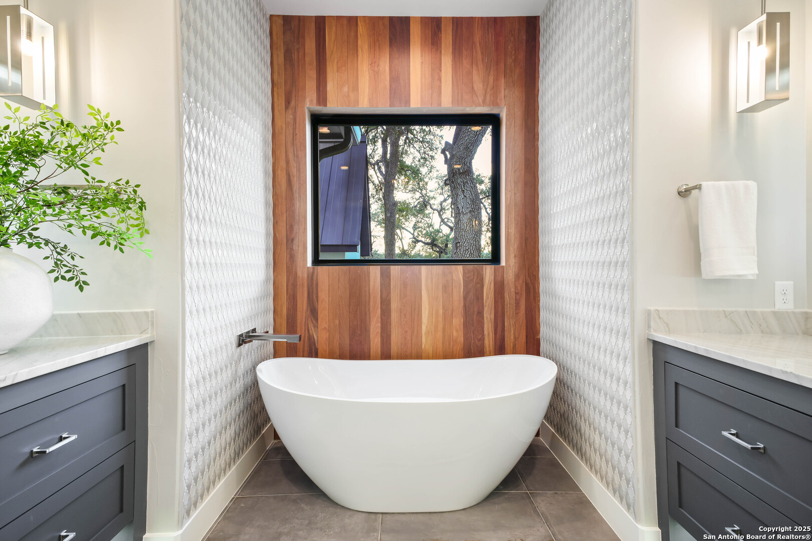 596 Ruger Road Fredericksburg, TX 78624 - Photo 25 of 63 a white tub sitting in a bathroom next to a window