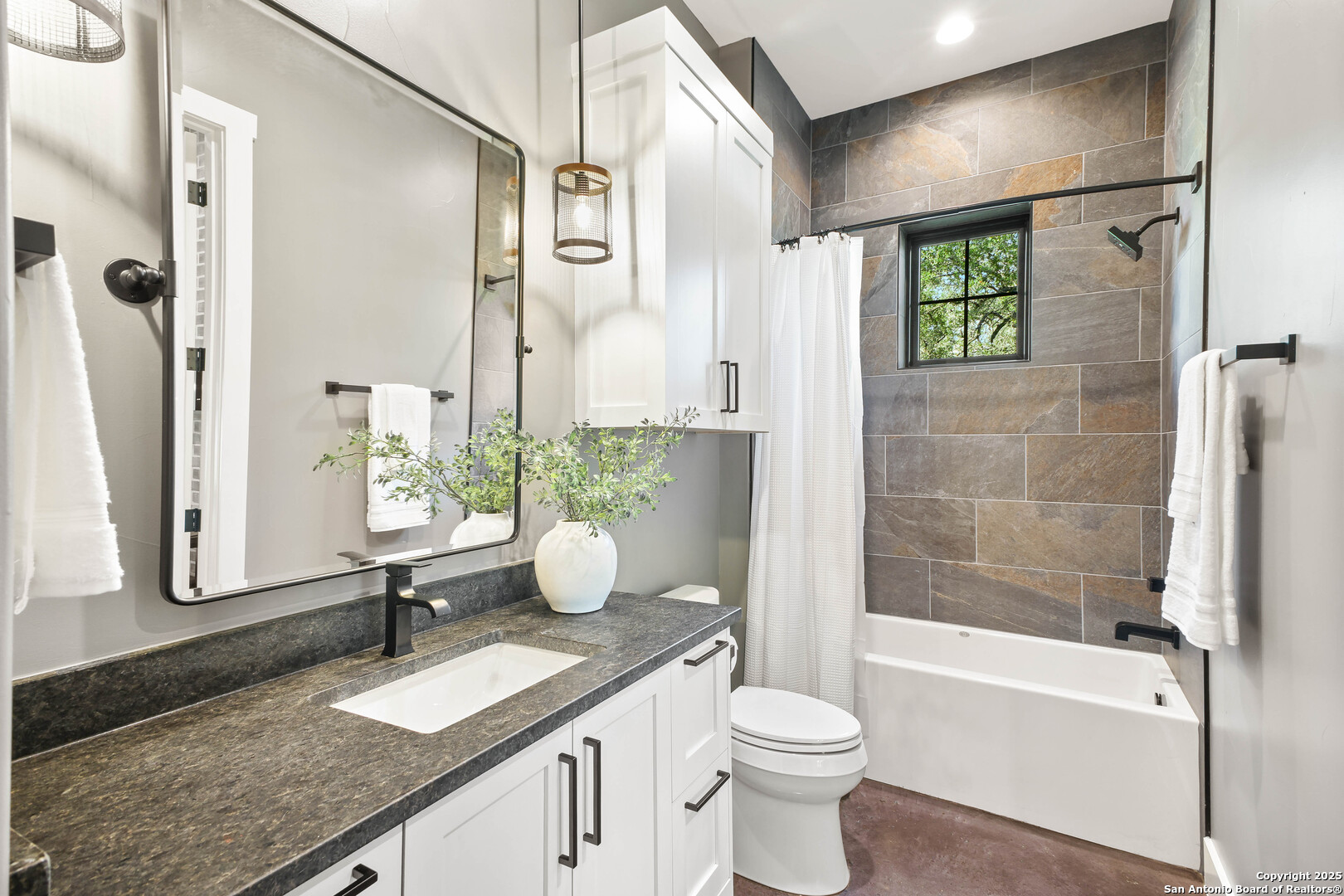 596 Ruger Road Fredericksburg, TX 78624 - Photo 32 of 63 a bathroom with a granite countertop sink toilet and shower