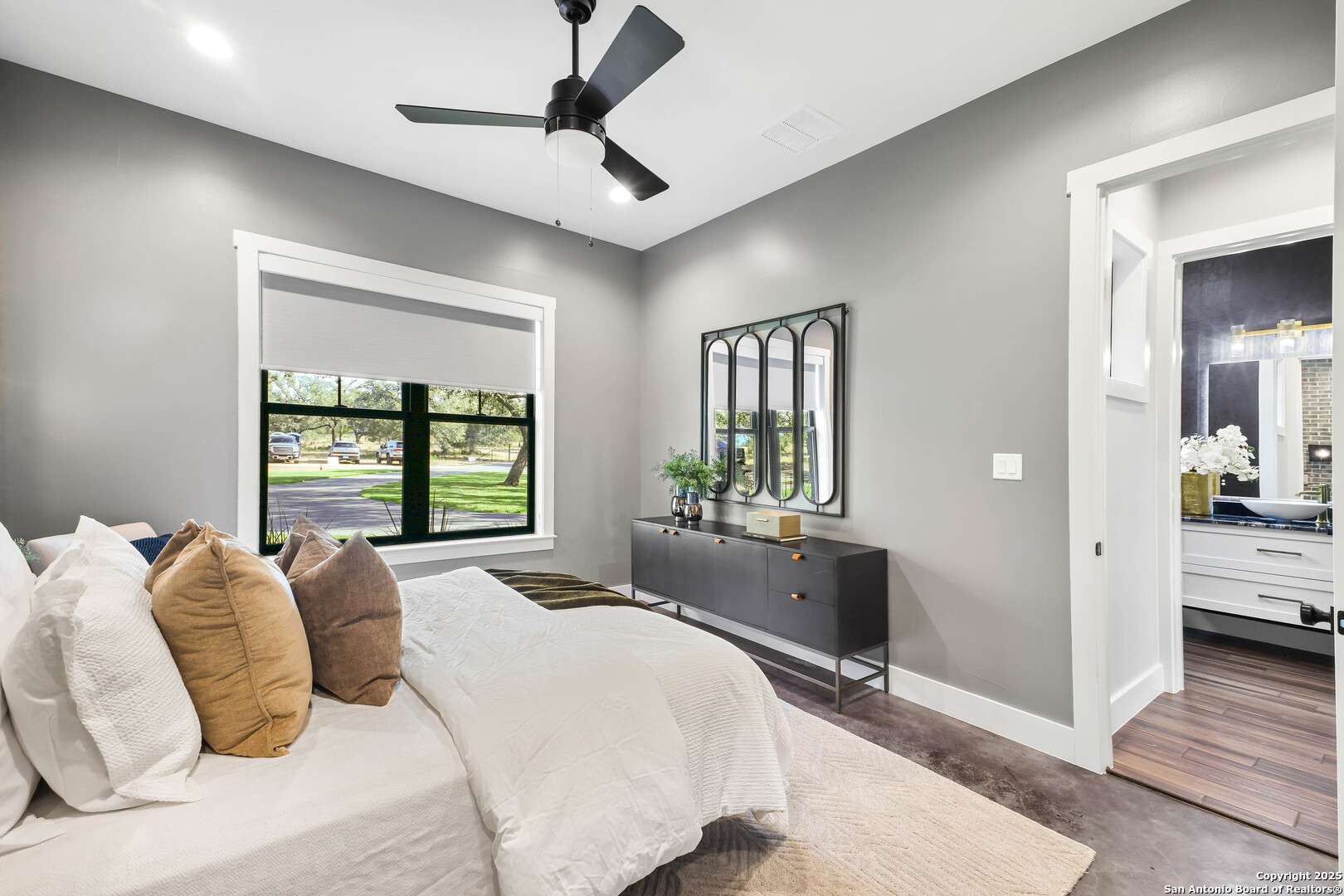 596 Ruger Road Fredericksburg, TX 78624 - Photo 33 of 63 a bedroom with a large bed and a window