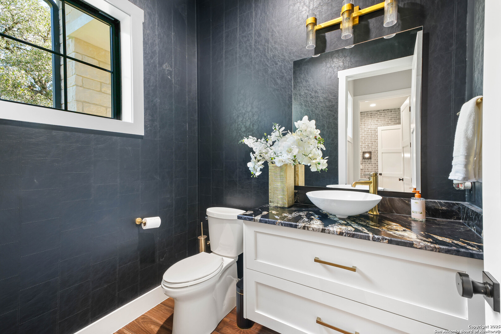 596 Ruger Road Fredericksburg, TX 78624 - Photo 34 of 63 a bathroom with a toilet sink and mirror