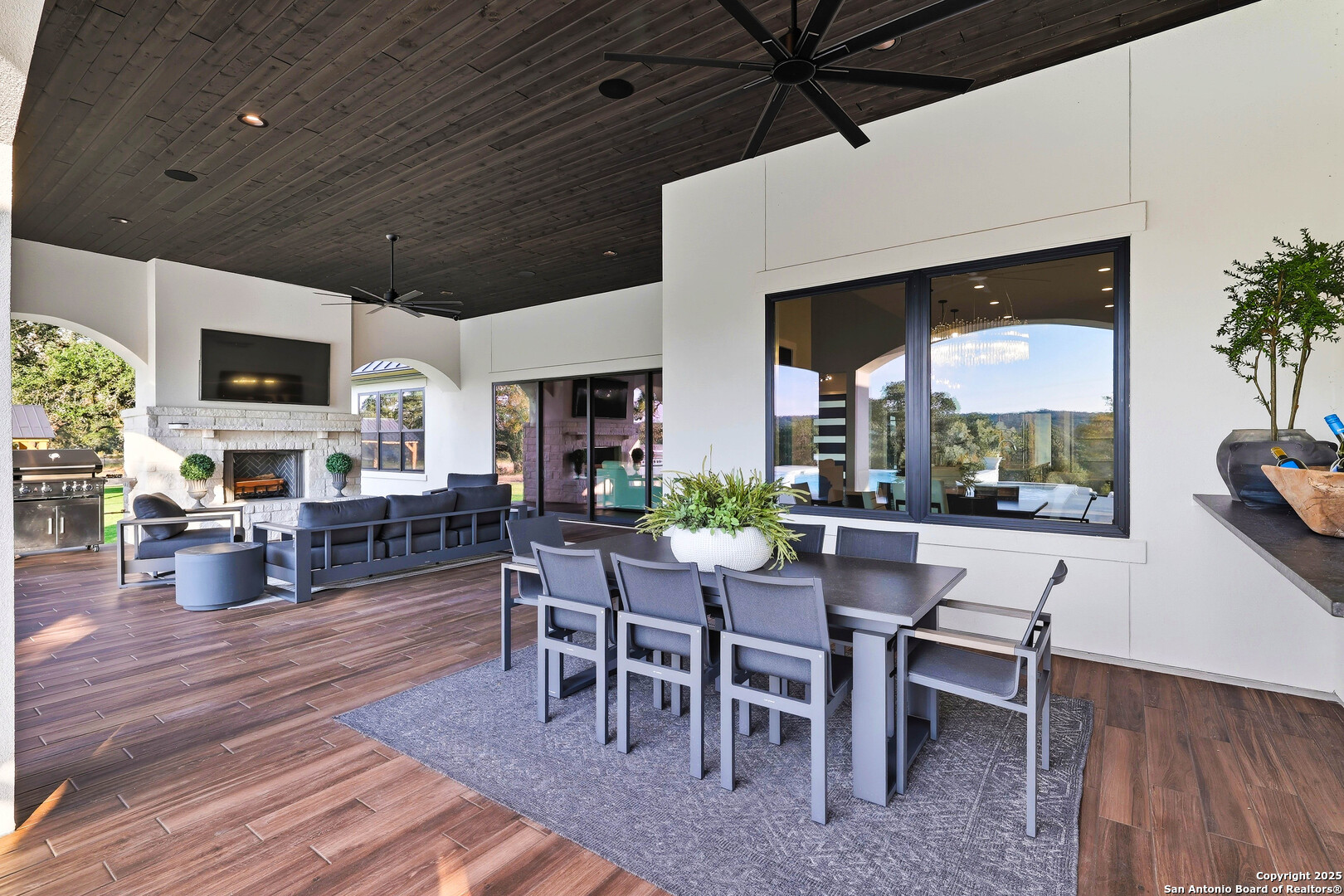 596 Ruger Road Fredericksburg, TX 78624 - Photo 35 of 63 a view of a dining room with furniture window and wooden floor