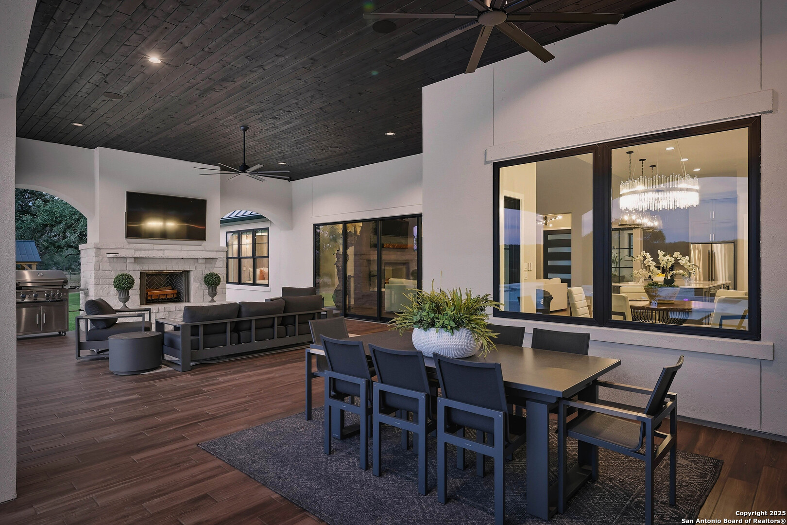 596 Ruger Road Fredericksburg, TX 78624 - Photo 37 of 63 a view of a dining room with furniture window and wooden floor