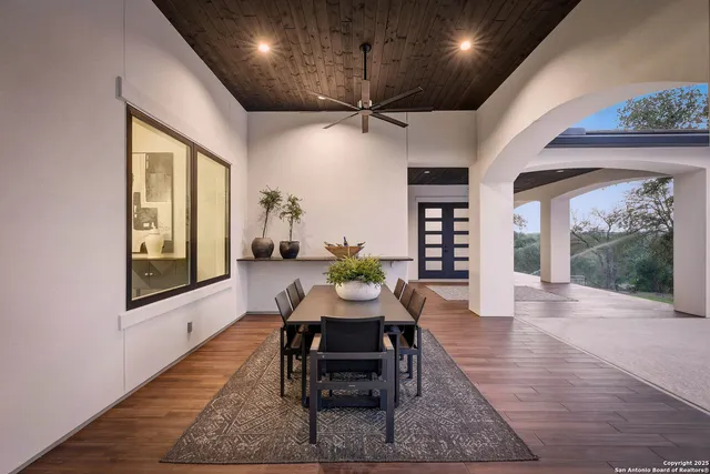 a living room with furniture a fireplace and a floor to ceiling window