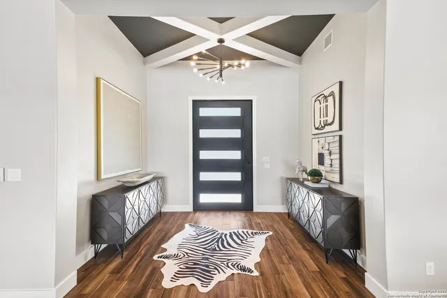 a living room with furniture a fireplace and wooden floor