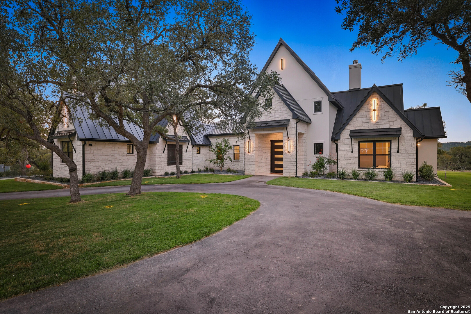 596 Ruger Road Fredericksburg, TX 78624 - Photo 63 of 63 a front view of a house with a garden and trees